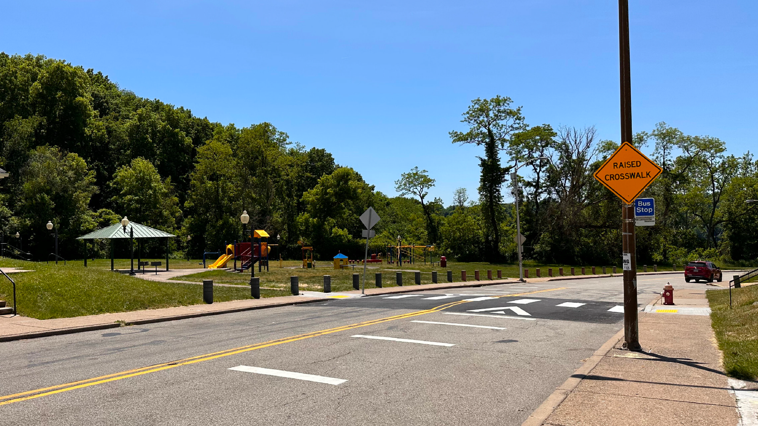 Image of a new raised crosswalk with a playground in the background