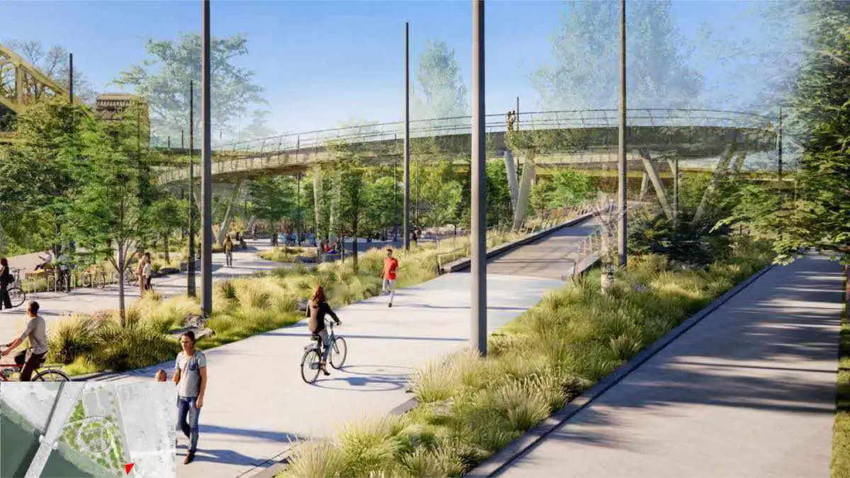 An artist's rendering of the view looking up the ramp.  In the foreground we see pedestrians and bicyclists using the ramp. In the background tall grass and trees line paved paths. A spiraling ramp shows access to the West End Bridg
